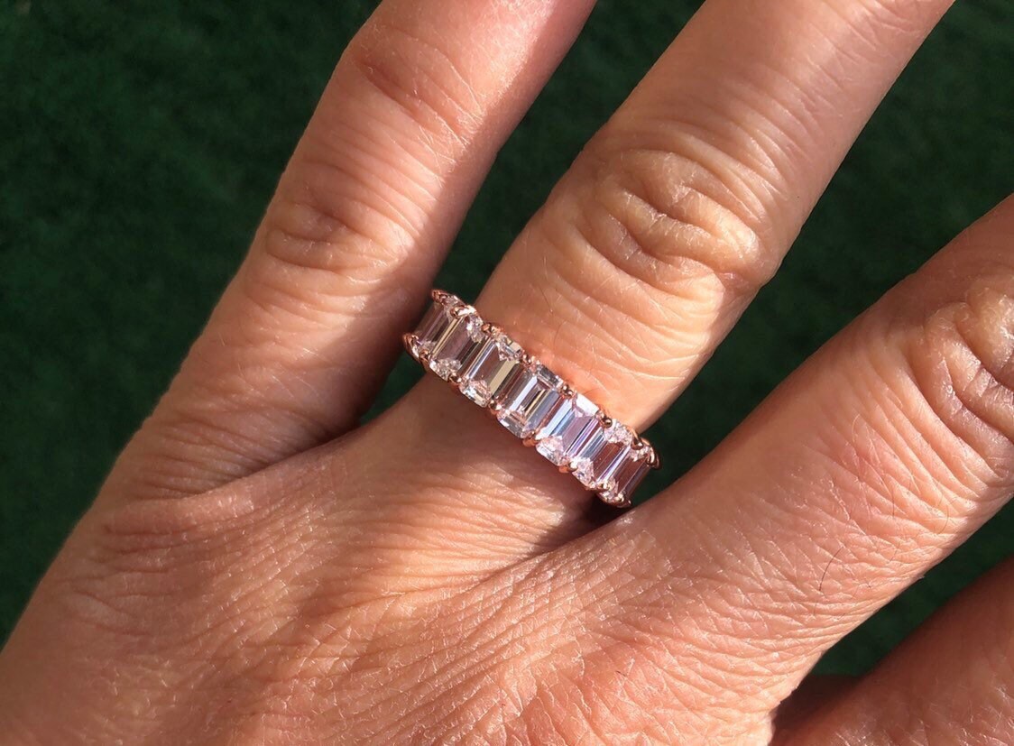 Emerald cut eternity band. Sterling Silver and Rose Gold Plated Baguette Style Eternity Band Ring with Clear Stones