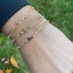 Custom name bracelet on a cuban link chain. Personalized name bracelet on a curb chain. Sterling silver gold plated nameplate bracelet.