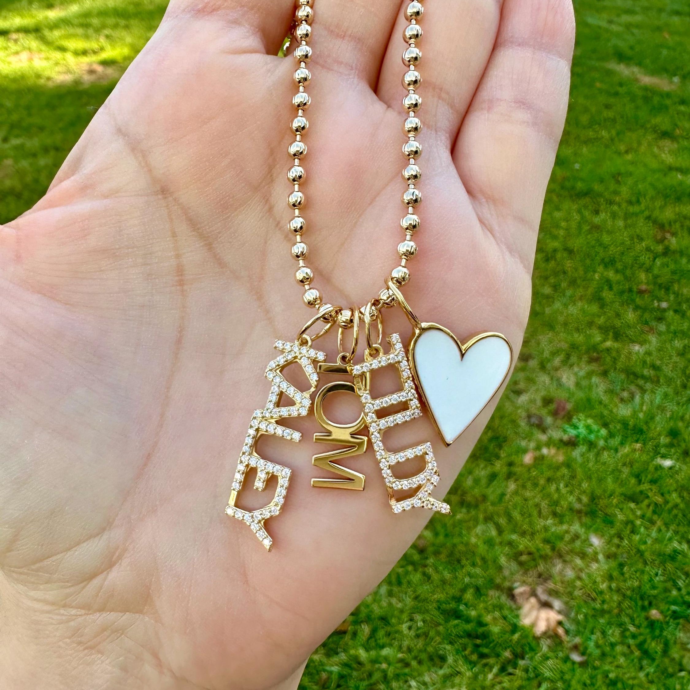 As seen on Caroline Baudino. Personalized Pave Name Charms. Diamond Charms. CZ charms. Custom name charms on Shop with Caroline.